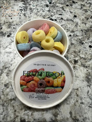 Selected Scent Fruit Loop cereal scented wax melts in colorful ring shapes with white container lid on marble surface