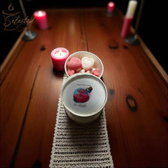 Selected Scent love spell wax melts in white tin with pink and white heart shaped melts on wooden table with candles