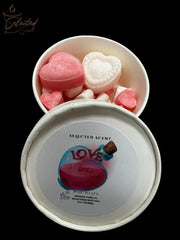 Selected Scent love spell wax melts in a white round tin showing pink and white heart shaped wax pieces
