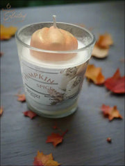 Selected Scent long lasting pumpkin candle 8oz with pumpkin-shaped wick in glass jar on autumn leaves