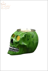 Green skull-shaped Electric Decorative Warmer with leaf pattern and white wax cubes on top