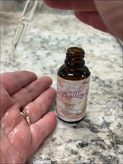 Selected Scent vanilla body oil being applied with dropper for hydrating and protecting skin