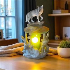 Selected Scent electric decorative warmer with cat and wildlife design glowing on wooden table