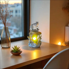 Selected Scent electric decorative warmer with wolf design glowing on wooden table near window