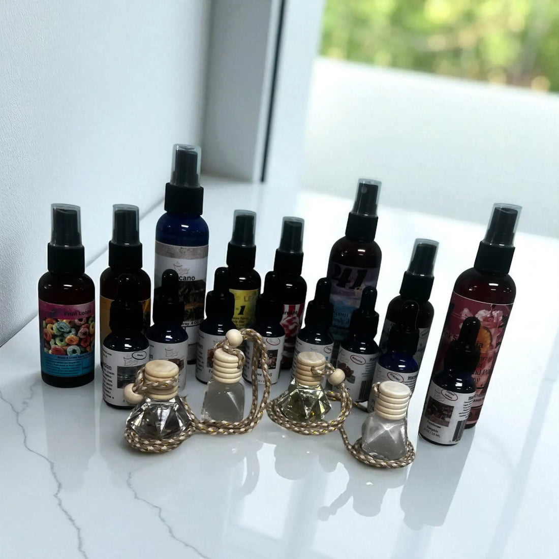 Collection of best home fragrance products including spray bottles and decorative scent diffusers on a white surface