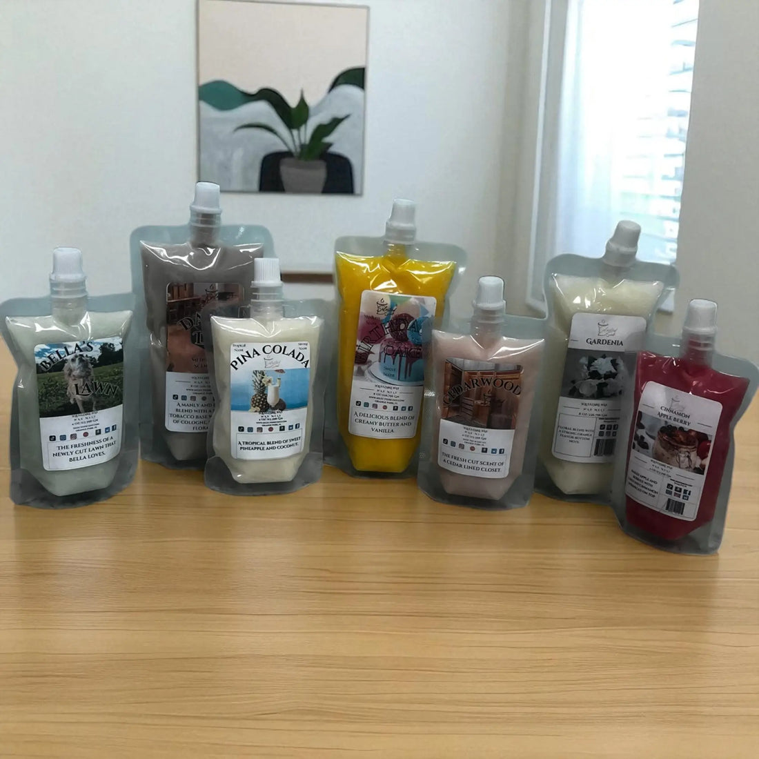 Assorted squeezable scented wax for warmers in various colors and fragrances displayed on a wooden surface