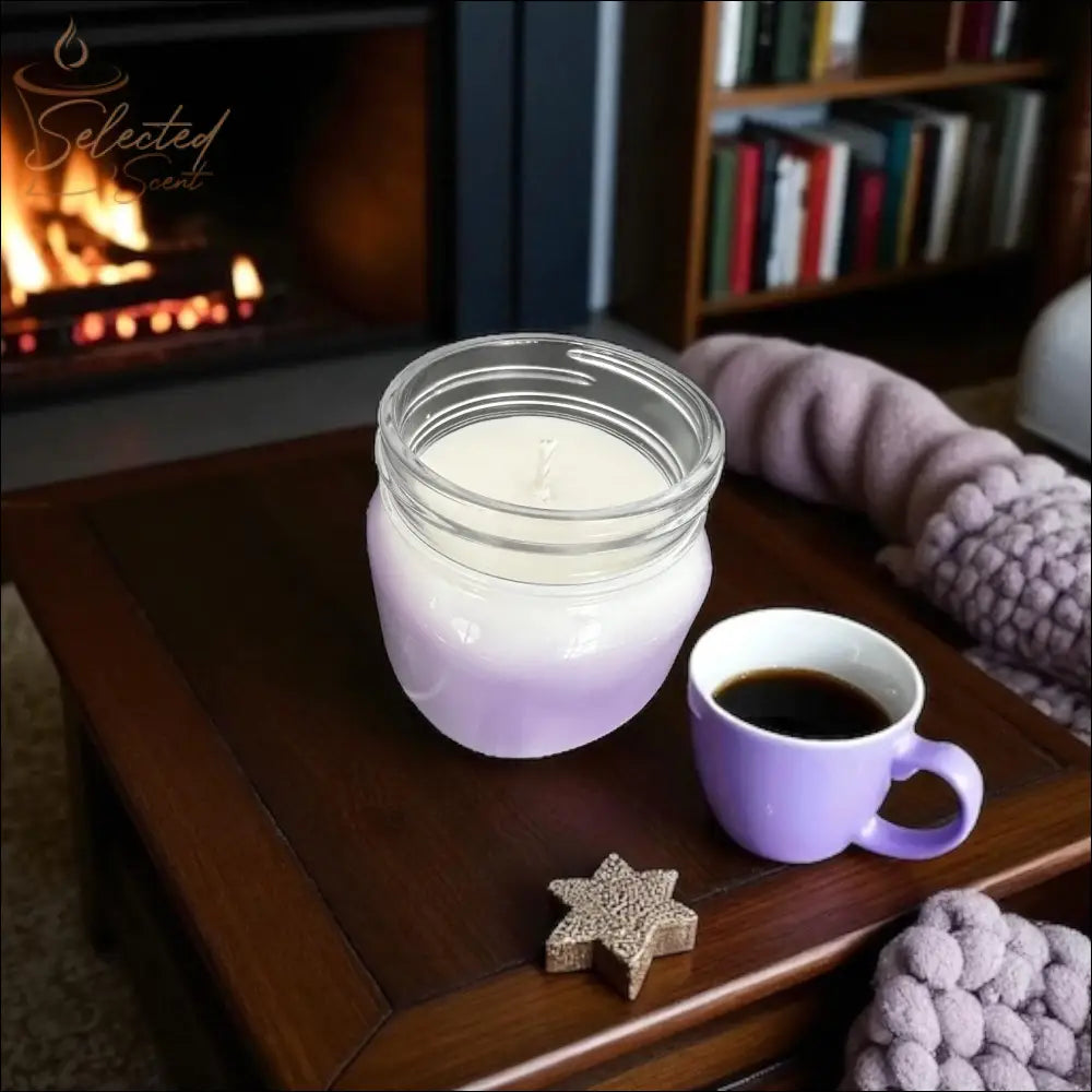 Selected Scent long lasting scented candle in lavender ombre jar on wooden table by fireplace with coffee cup and cozy blanket