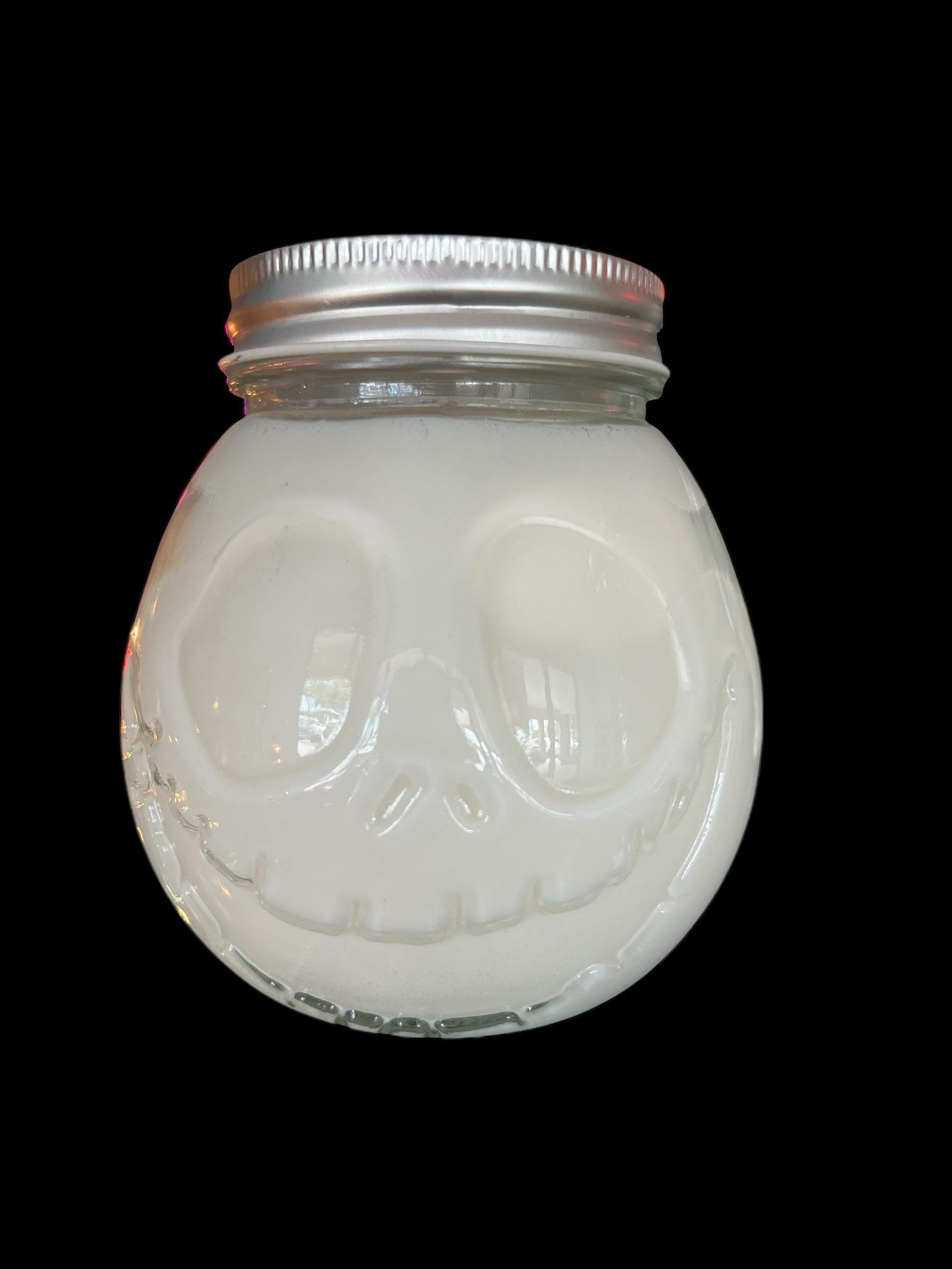 Selected Scent 16 oz pumpkin spice candle cup in a glass jar with a skull face design and metal lid