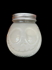 Selected Scent 16 oz pumpkin spice candle cup in a glass jar with a skull face design and metal lid