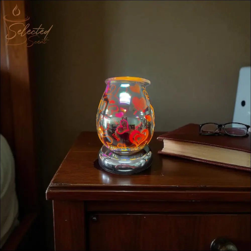 Selected Scent Electric Decorative Warmer with red heart designs glowing on wooden nightstand