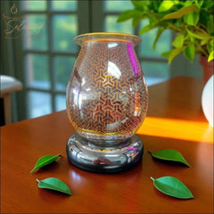 Selected Scent Electric Decorative Warmer with geometric glass design on wooden table with green leaves