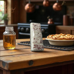 Selected Scent all natural wax melts bar with speckles on wooden kitchen table near pie and jar