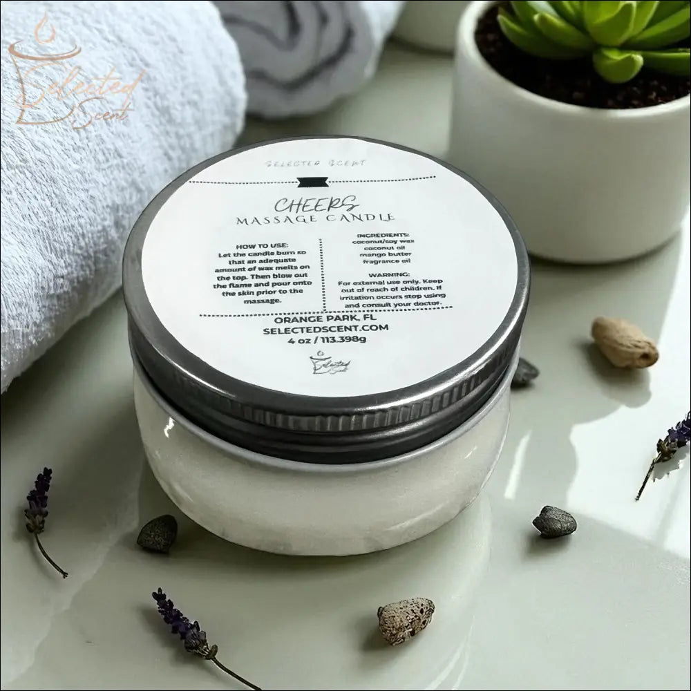 Selected Scent massage candle with mango butter in glass jar and metal lid on table with towel and plant