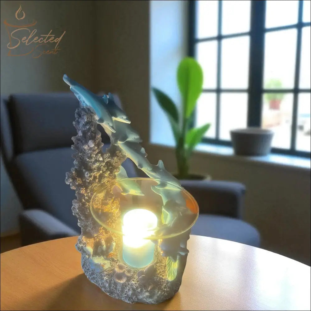 Selected Scent family dolphin aromatherapy burner with dolphins and glowing light on wooden table