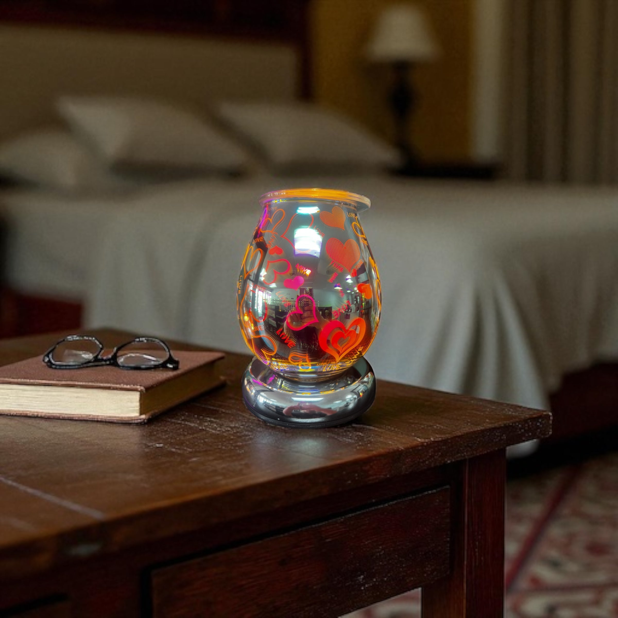 Selected Scent Electric Decorative Warmer with colorful heart designs on wooden bedside table