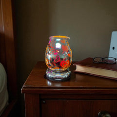 Selected Scent Electric Decorative Warmer with red heart designs glowing on wooden nightstand