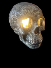 Selected Scent electric decorative warmer shaped like a detailed silver skull with light glowing from the eye sockets