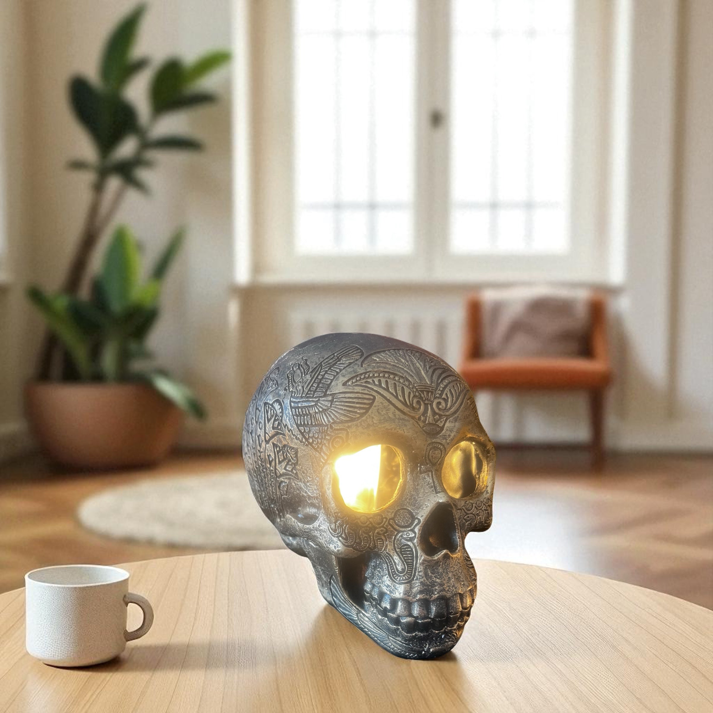 Selected Scent Electric Decorative Warmer shaped like an engraved skull with glowing eyes on a wooden table