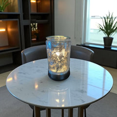 Selected Scent electric decorative warmer with floral design lit on white marble table
