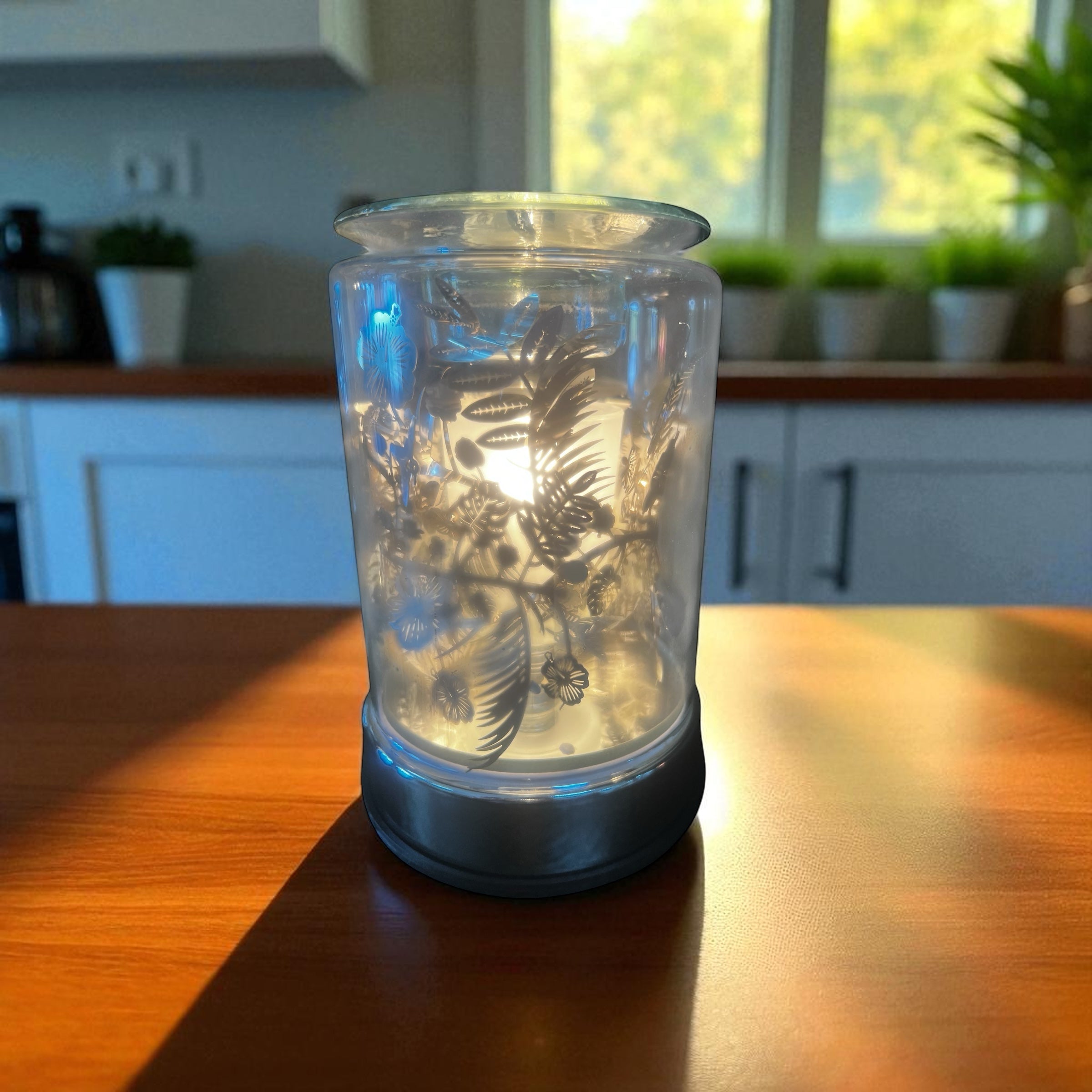 Selected Scent Electric Decorative Warmer with floral design glowing on wooden table
