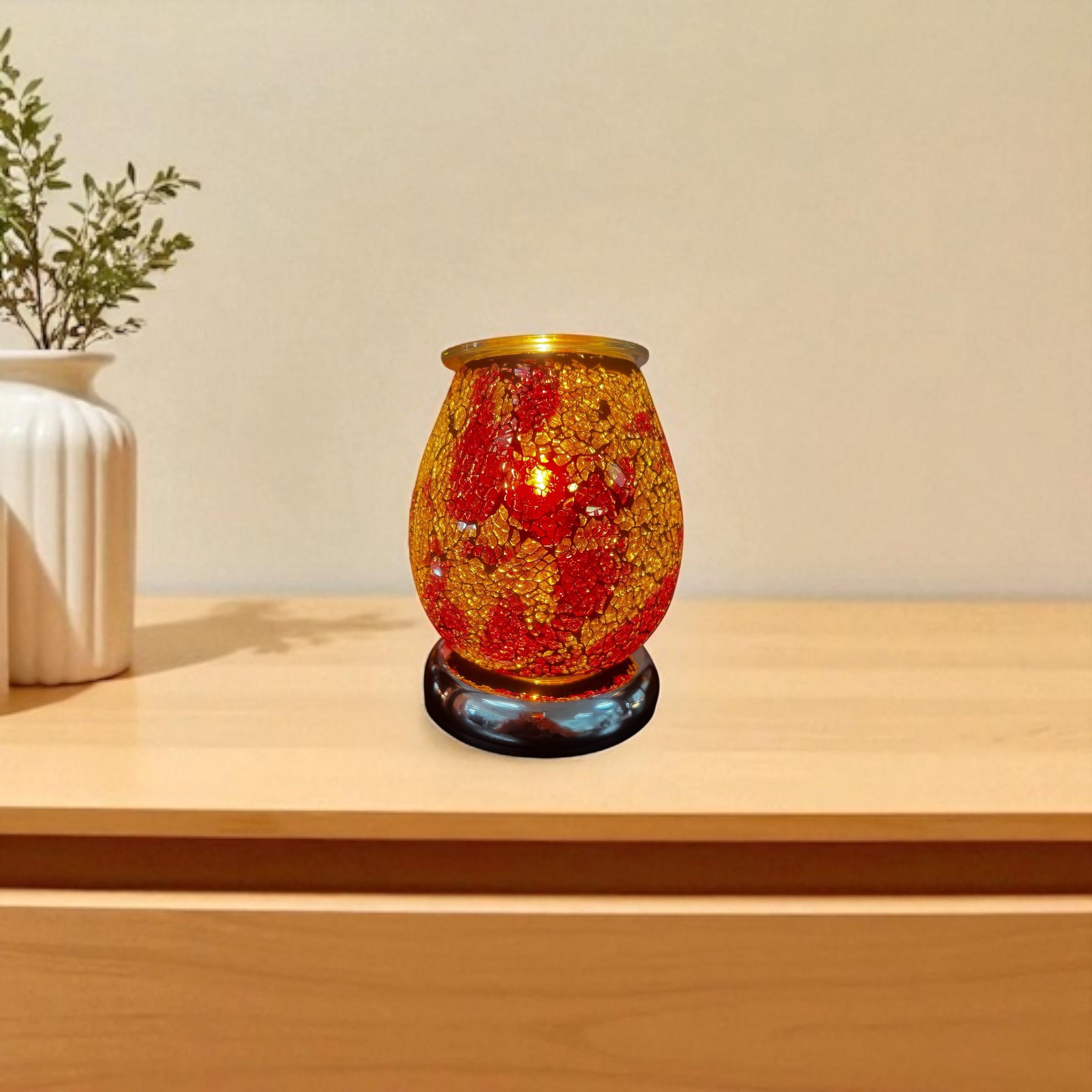 Selected Scent electric decorative warmer with red and gold mosaic glass design on wooden table