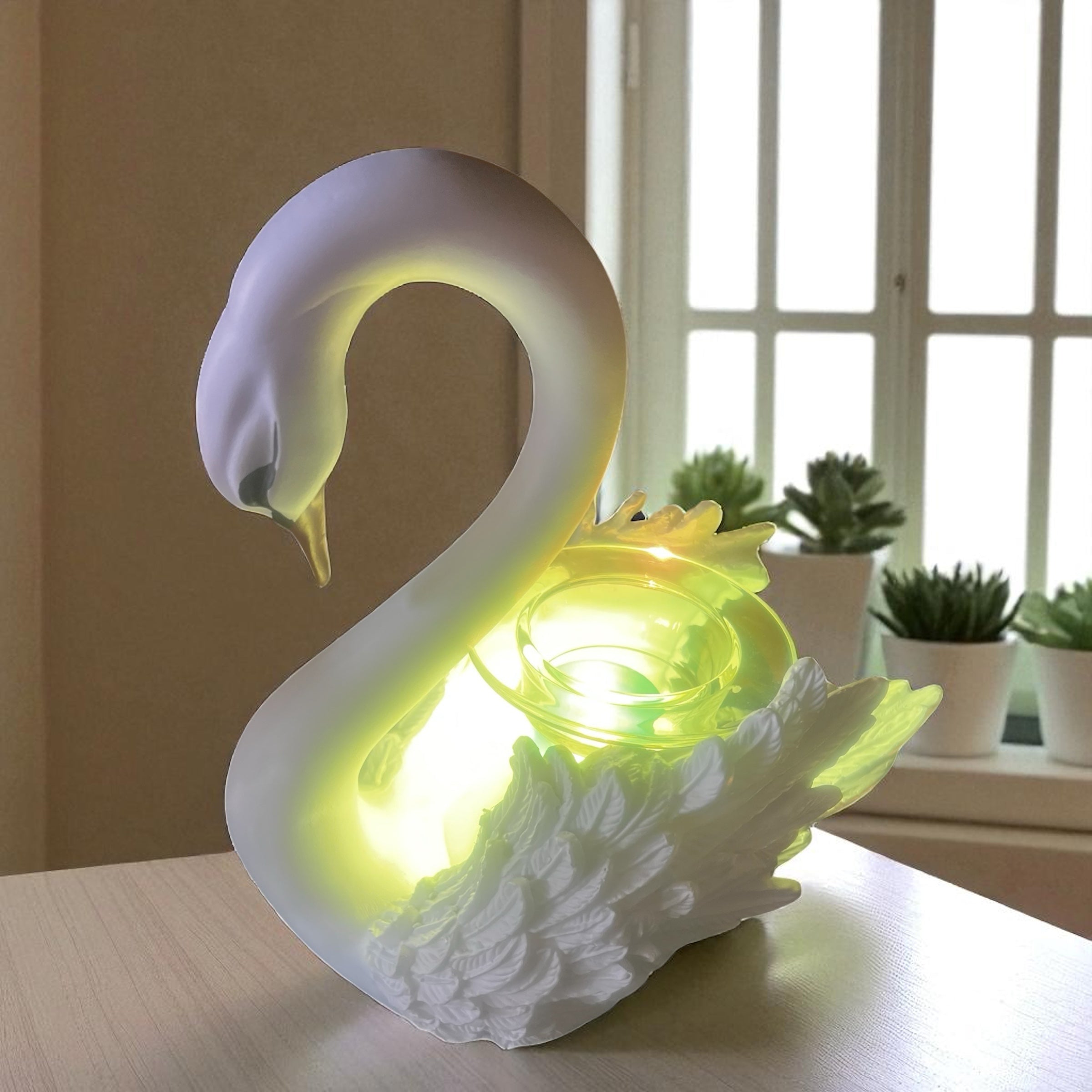 Selected Scent electric decorative warmer in white swan shape glowing softly on wooden table
