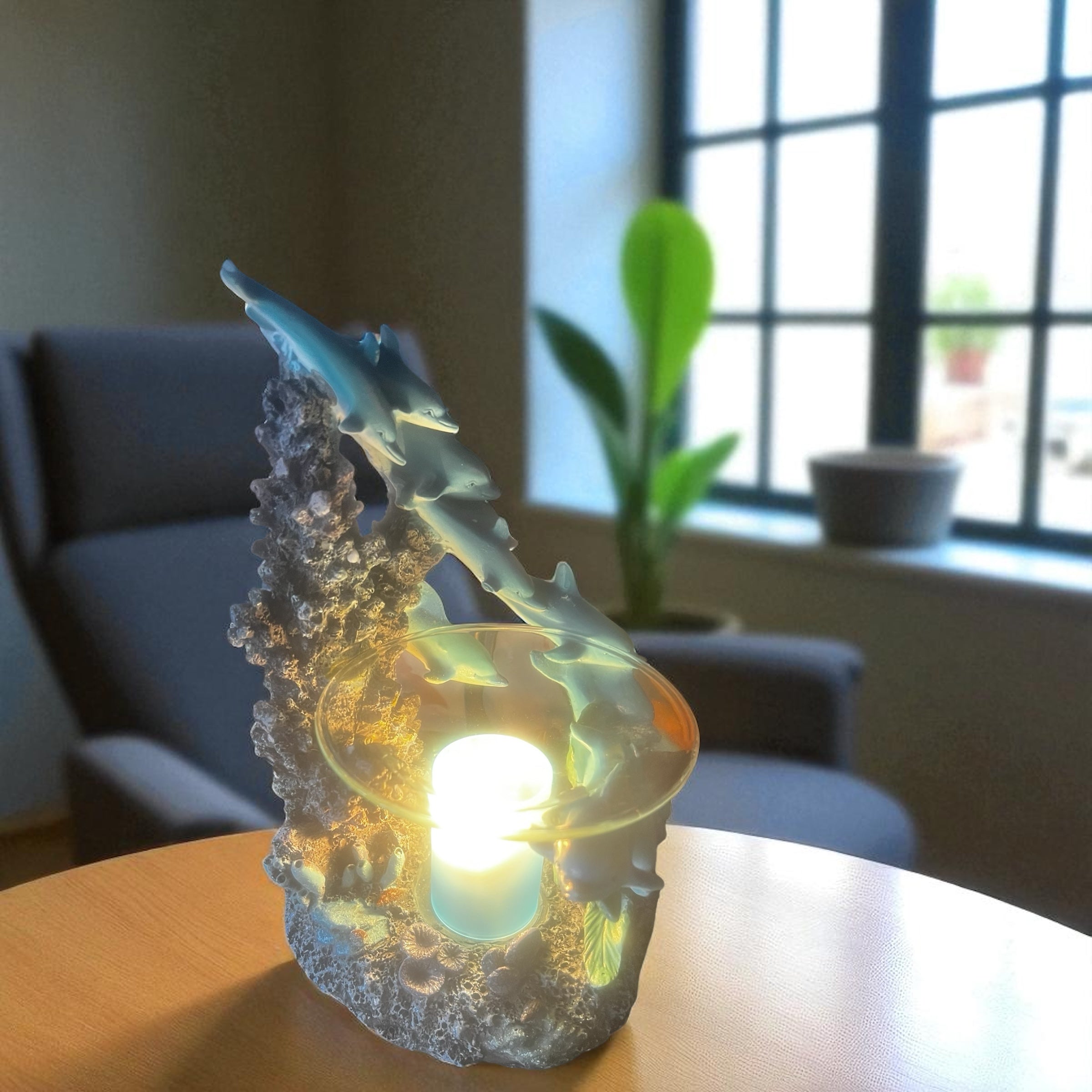 Selected Scent family dolphin aromatherapy burner with dolphins and glowing light on wooden table