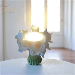 Selected Scent Electric Decorative Warmer with white flower design glowing on a table