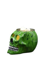 Green skull-shaped Electric Decorative Warmer with leaf pattern and white wax cubes on top