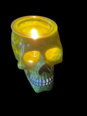 Selected Scent Electric Decorative Warmer shaped like a glowing green skull with a lit candle inside