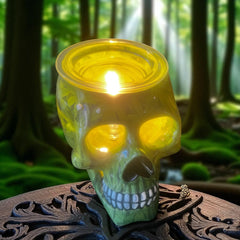 Selected Scent electric decorative warmer shaped like a glowing yellow skull on wooden surface