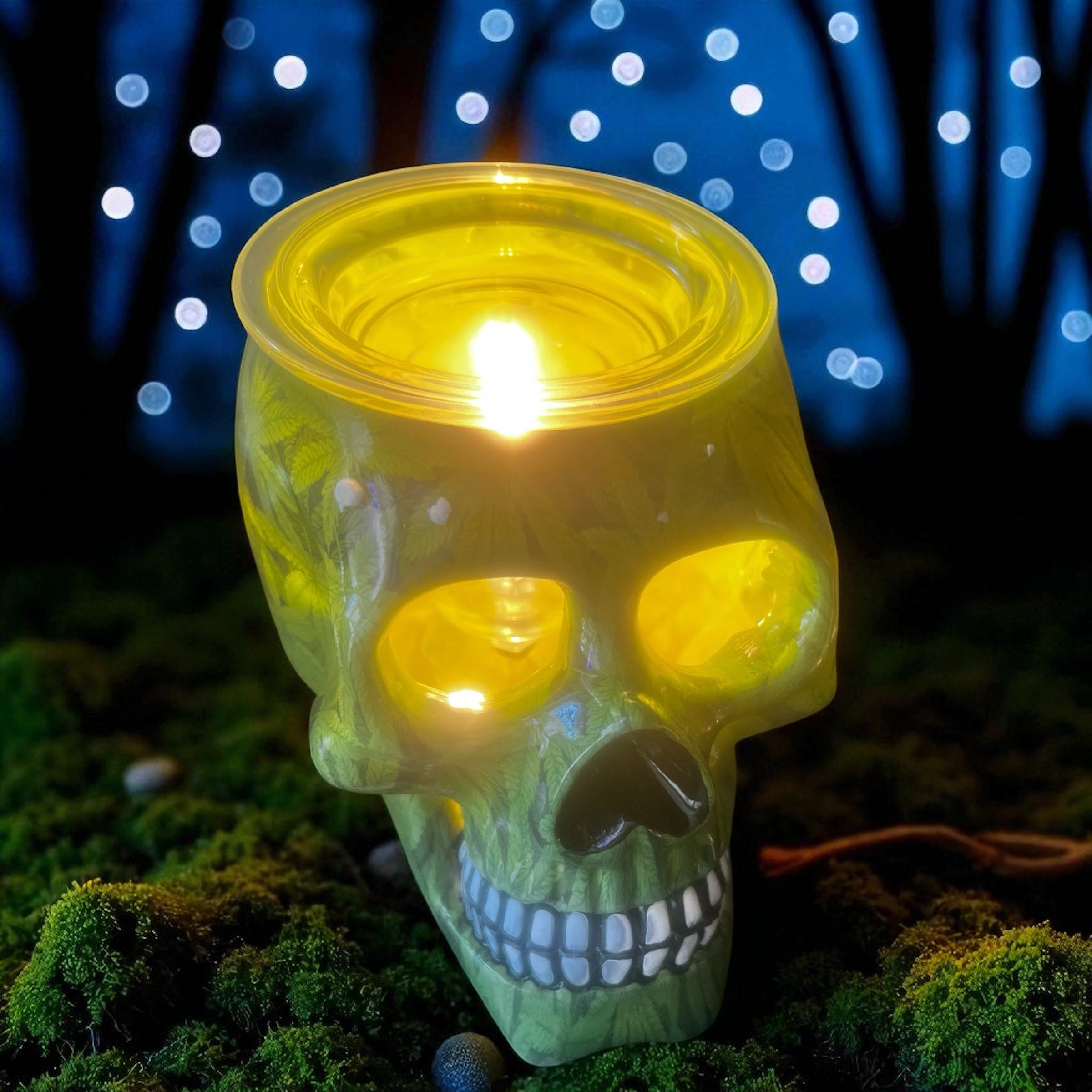 Selected Scent green skull electric decorative warmer glowing with light on moss background