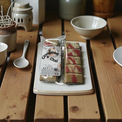 Selected Scent cinnamon chai scented home decor wax melts on wooden table with ceramic dishes