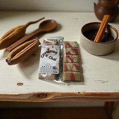 Selected Scent cinnamon chai scented home decor wax melts with cinnamon stick and wooden spoon on rustic table