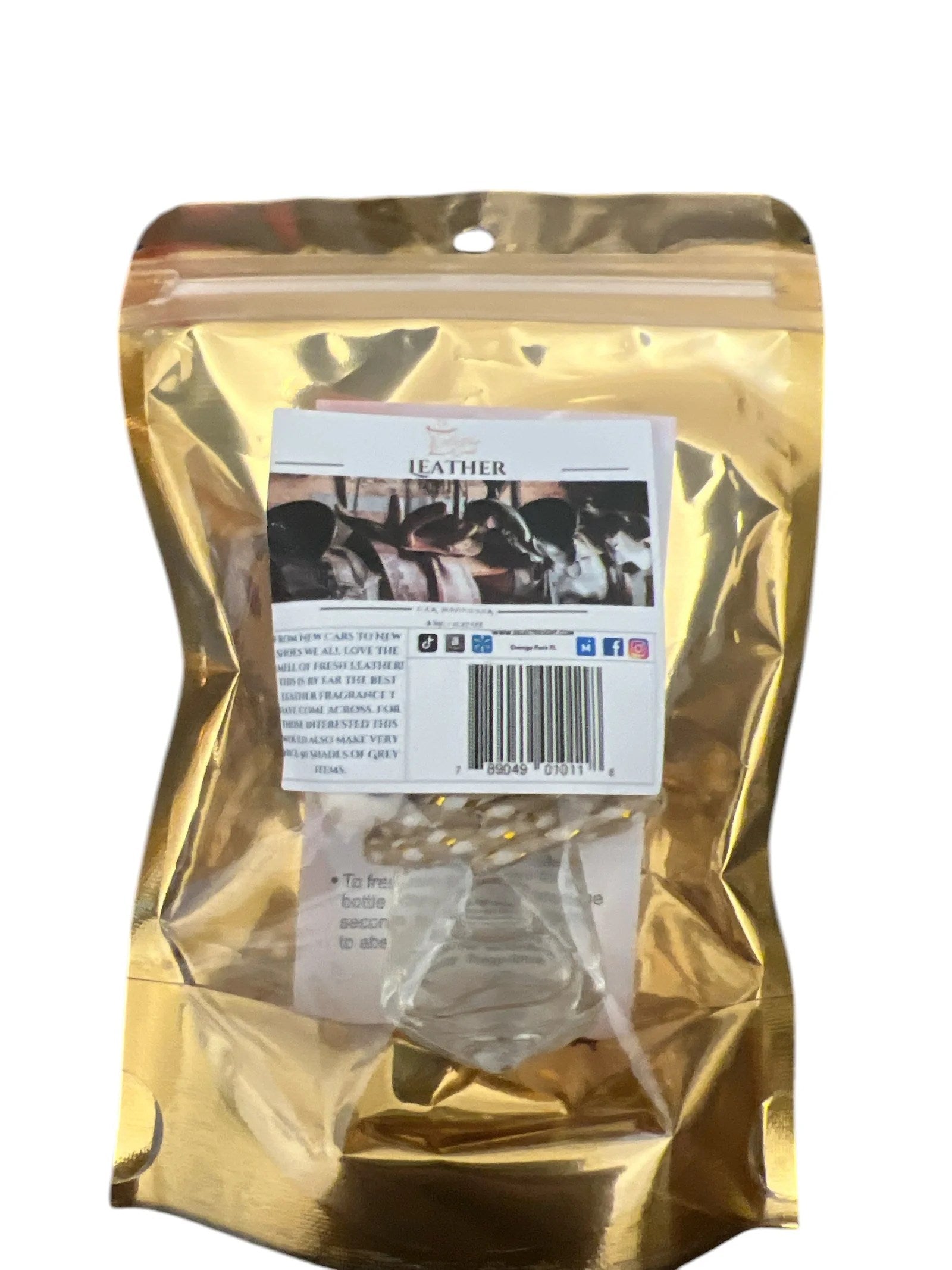 Selected Scent long lasting car air freshener in leather scent with clear bottle in gold packaging