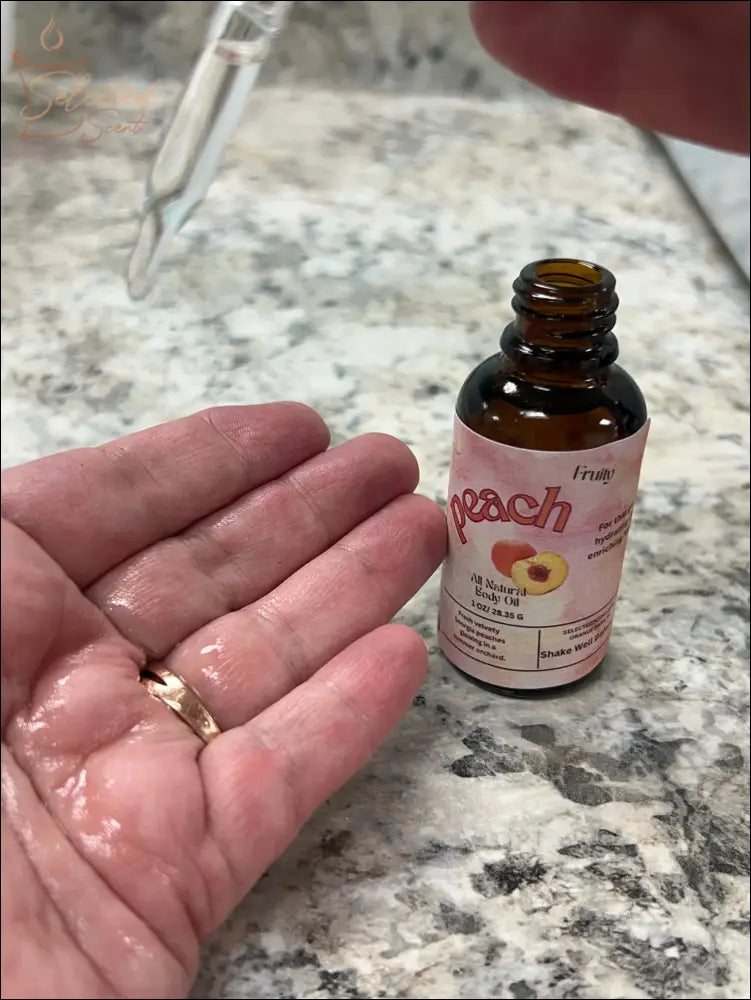 Selected Scent peach oil dropper applying hydrating and protecting facial oil on hand