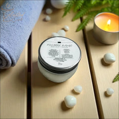 Selected Scent pineapple mango massage candle with mango butter on wooden surface near towel and lit candle