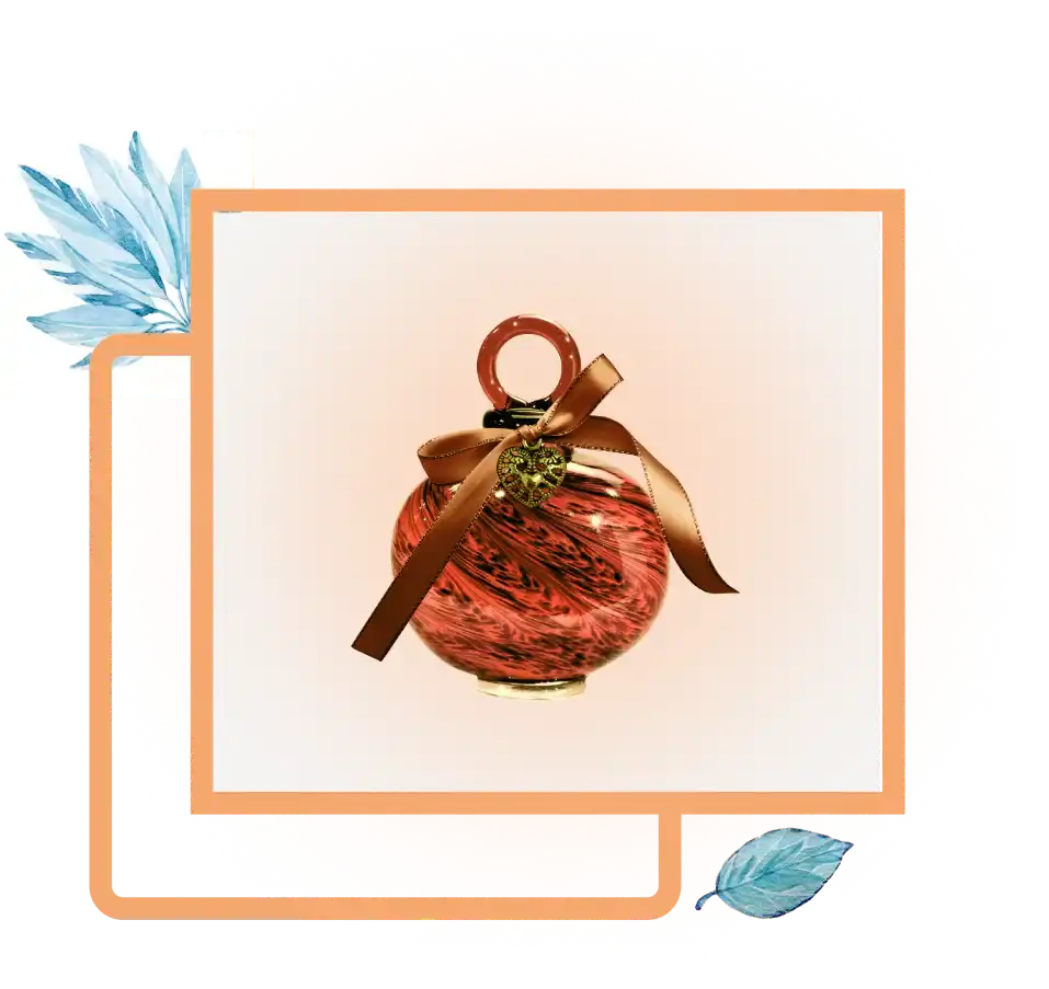 A round, ornate, red and black marbled glass Christmas ornament with a brown ribbon and a golden charm.