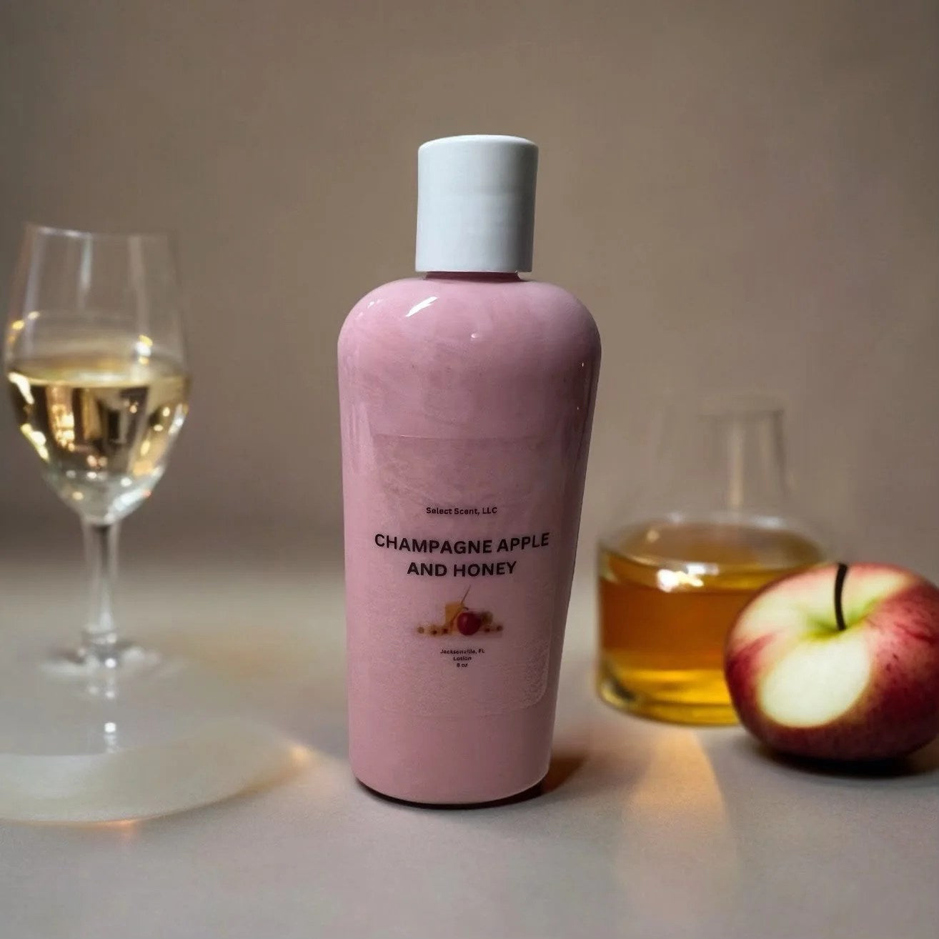 Selected Scent vitamin e moisturizing lotion in champagne apple and honey scent bottle with apple and glass accessories