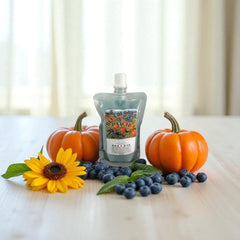 Selected Scent fall seasonal favorites pouch with pumpkins, blueberries, and sunflower on wooden table