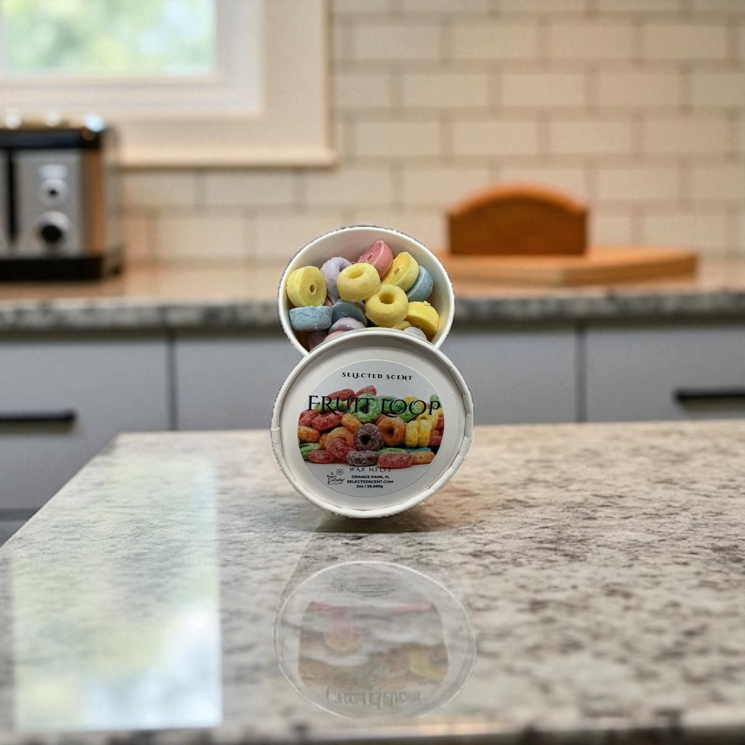 Selected Scent cereal scented wax melts in a white round container on kitchen countertop