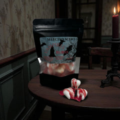 Selected Scent unique spooky wax melts shaped like vampire teeth with red blood drips on wooden table