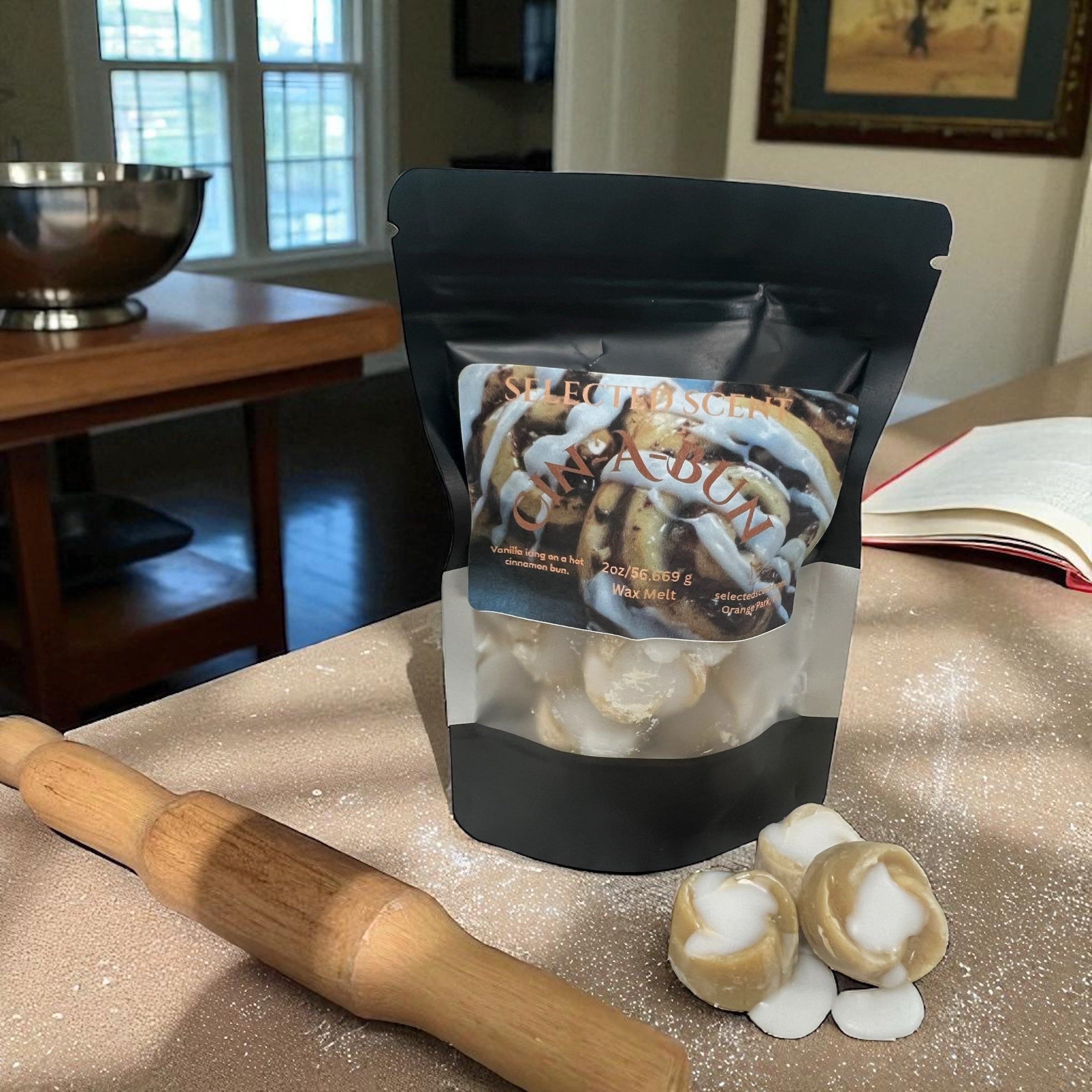 Selected Scent long lasting bakery scented wax melt package with cinnamon rolls and rolling pin on counter