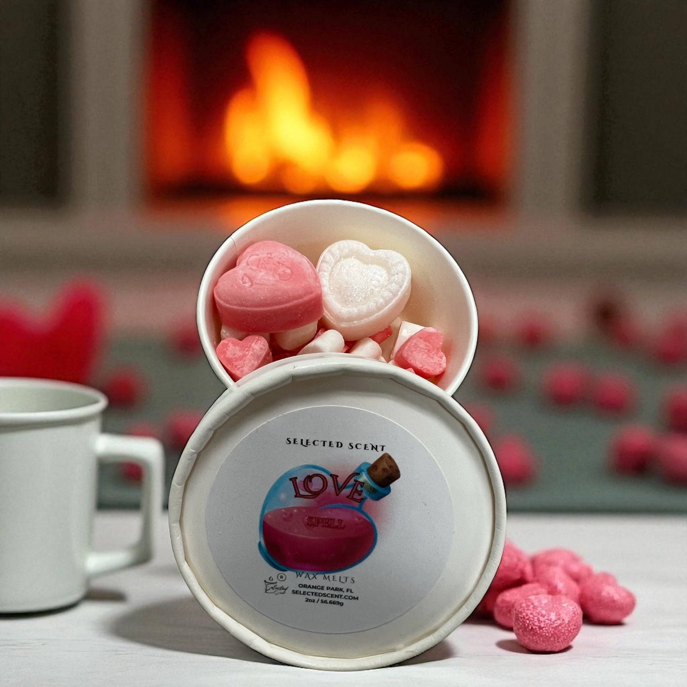 Selected Scent love spell wax melts pink and white heart shaped wax melts in open round tin by fireplace