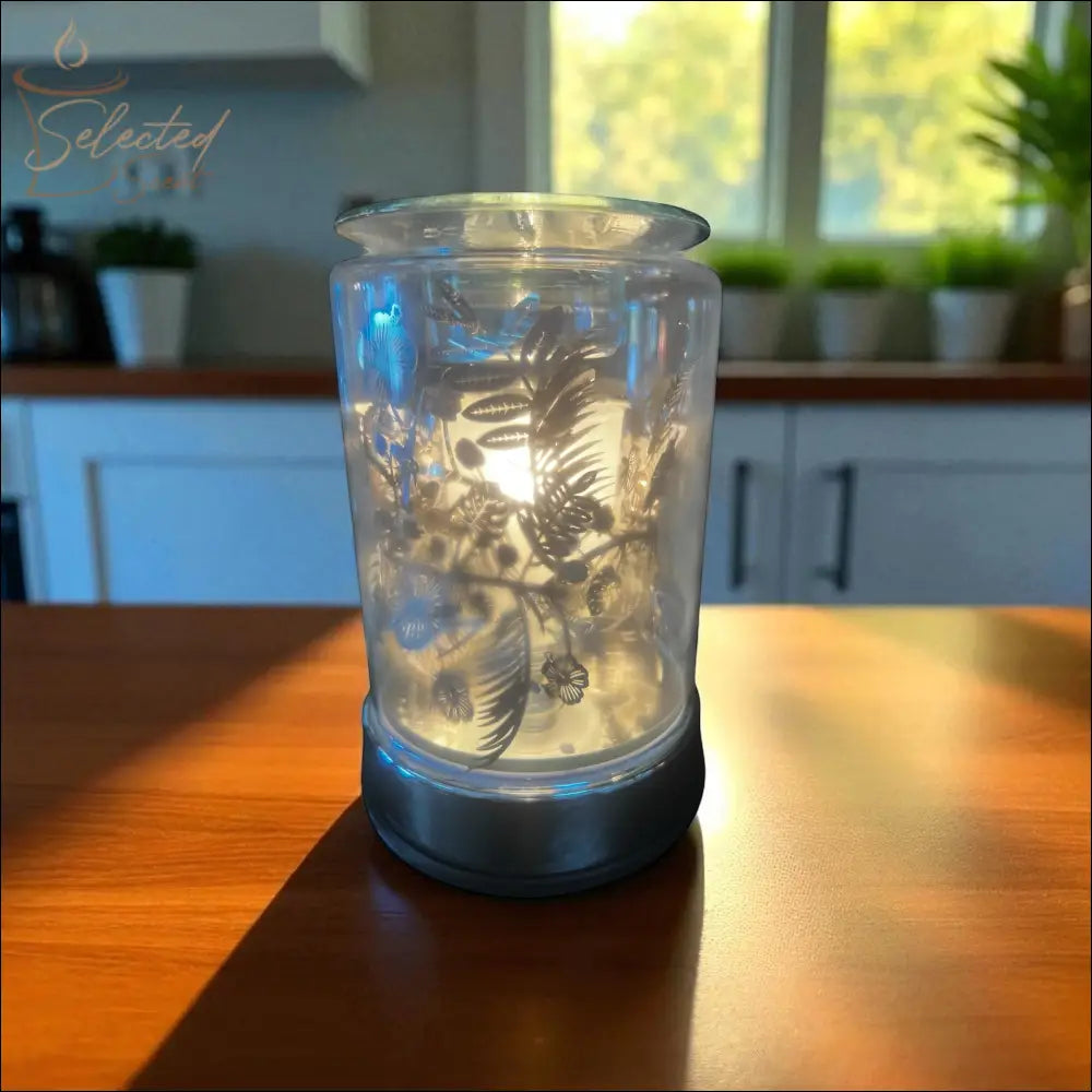 Selected Scent Electric Decorative Warmer with floral design glowing on wooden table