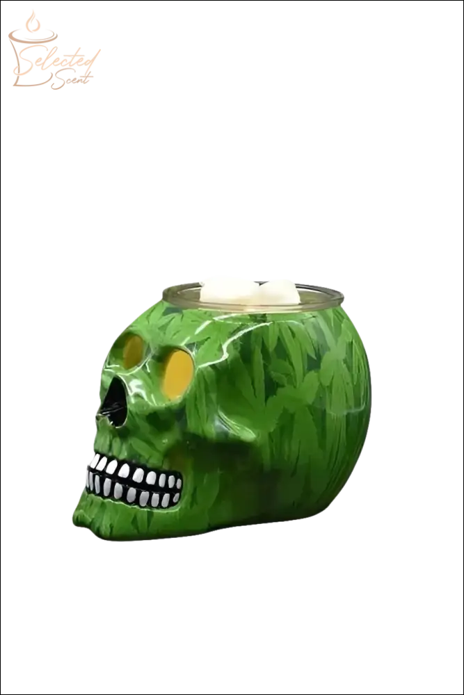 Green skull-shaped Electric Decorative Warmer with leaf pattern and white wax cubes on top