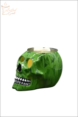 Green skull-shaped Electric Decorative Warmer with leaf pattern and white wax cubes on top