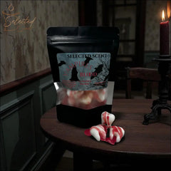Selected Scent unique spooky wax melts shaped like vampire teeth with red blood drips on wooden table