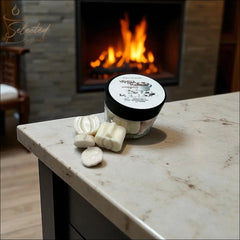 Selected Scent jar of vanilla pumpkin marshmallow wax melts on marble counter by cozy fireplace