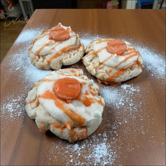 Selected Scent three handcrafted vanilla pumpkin spice wax melts resembling frosted cookies with orange drizzle